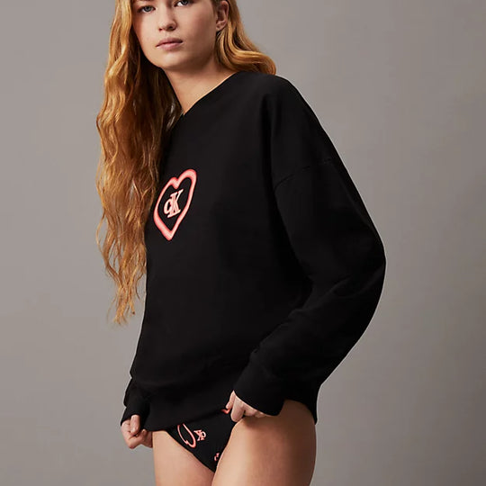 Calvin Klein CK96 Womens Lounge Sweatshirt Black side view on model with long hair, featuring logo print and relaxed fit.