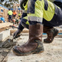 Apache AP305 Unisex Rigger Boots Brown side view worn by a worker on a construction site, highlighting comfort and style.