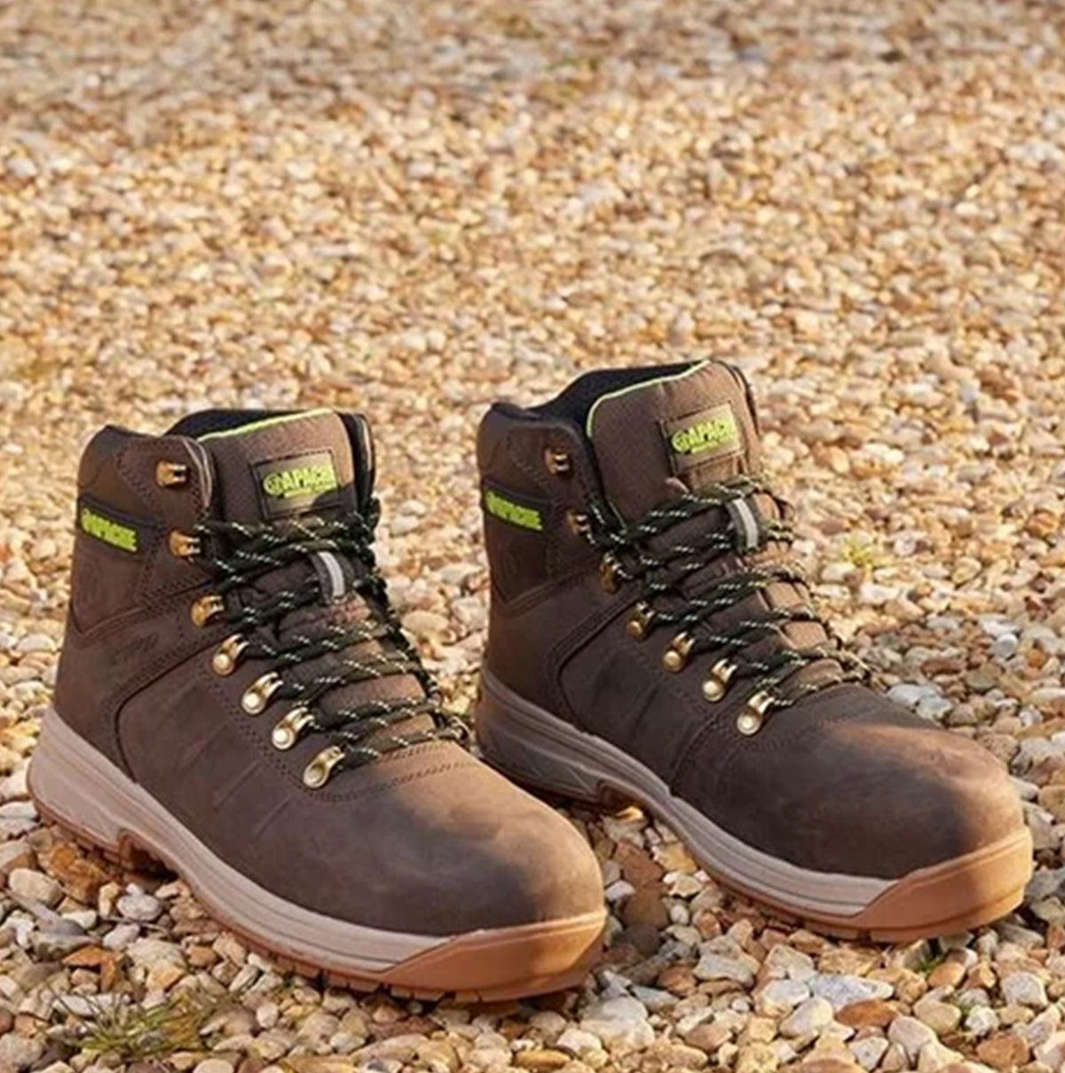 Apache MOOSE Unisex Boots Brown side view showcasing lace-up design and rubber sole on gravel surface.