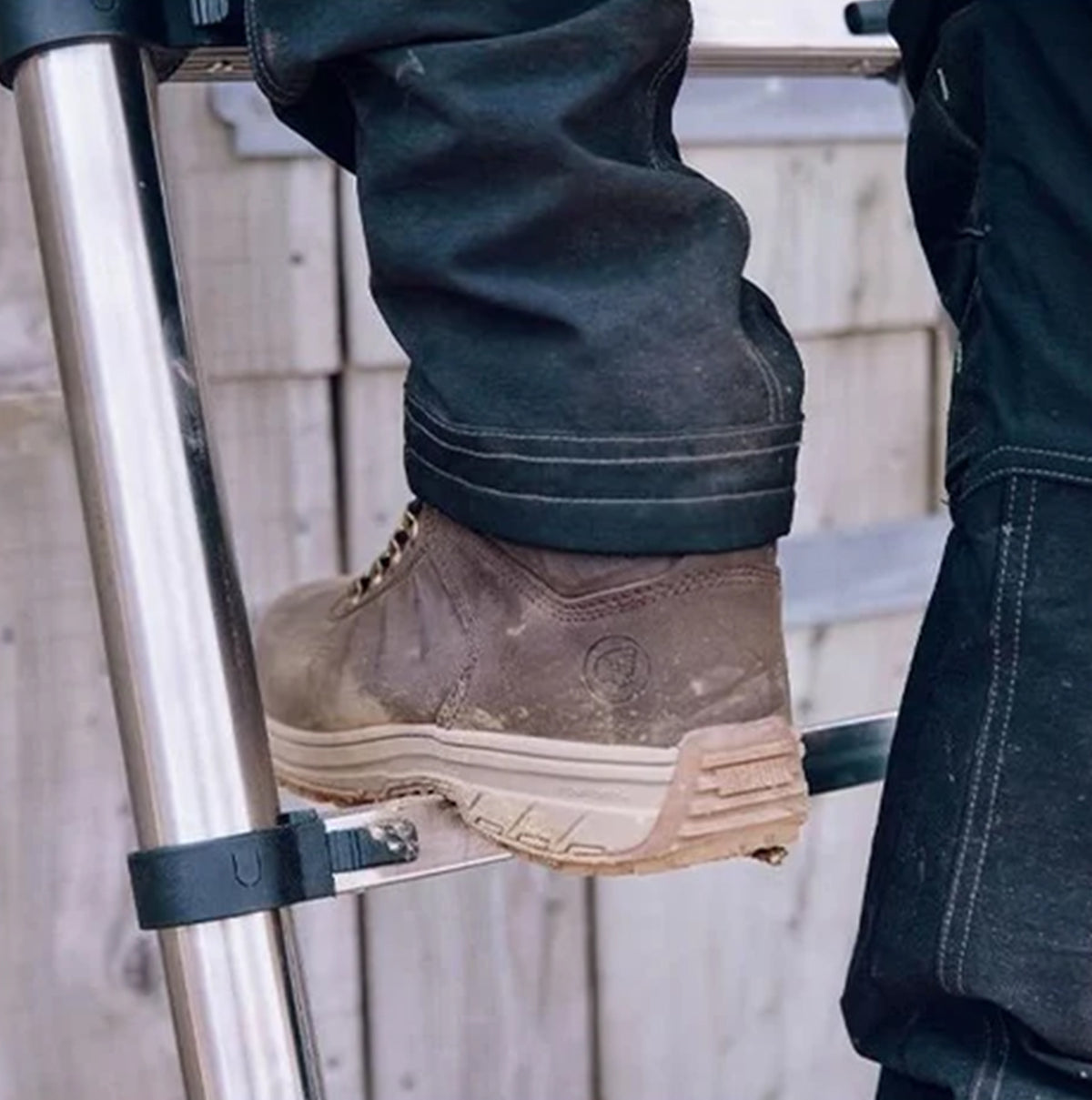 Apache MOOSE Unisex Boots Brown side view worn on a ladder, showcasing the durable nubuck upper and rubber sole.