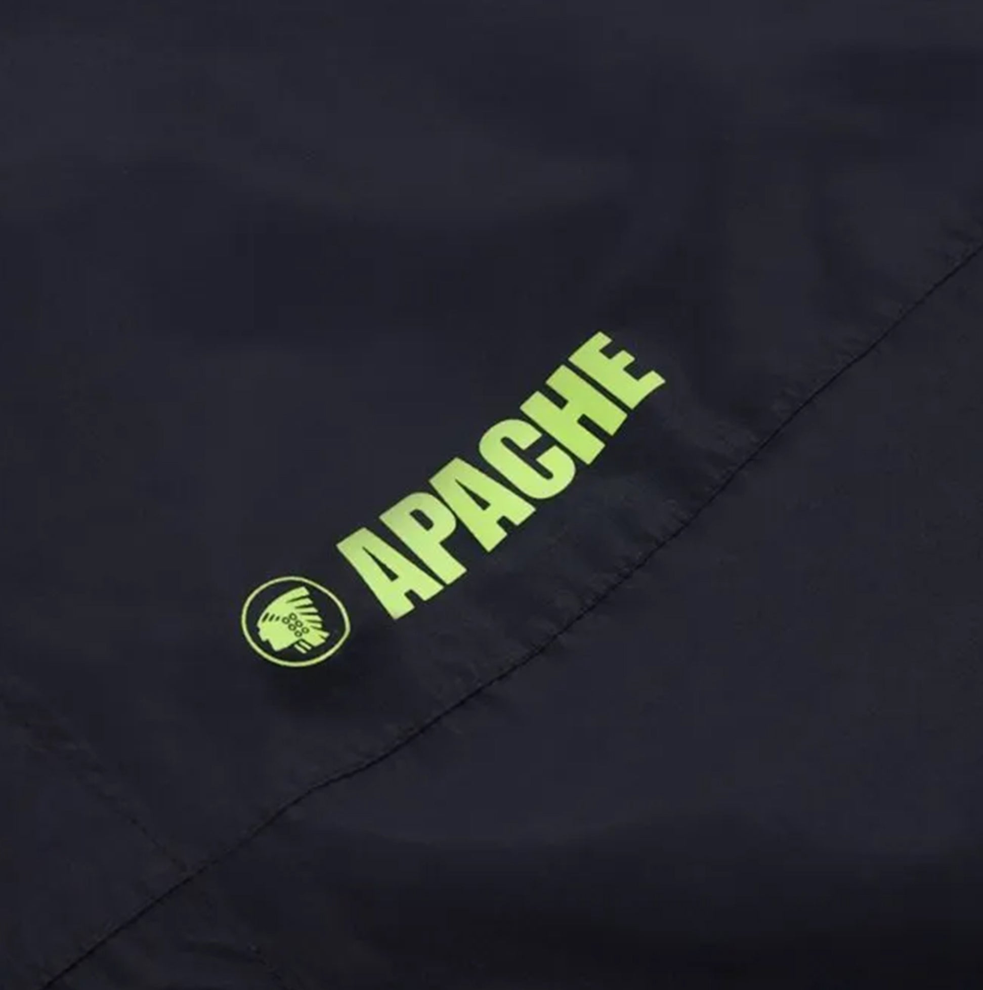Apache QUEBEC Mens Over Trousers Black logo detail view on fabric with visible brand name in bright green.
