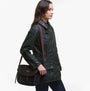 Barbour CROMARTY Crossbody Bag Womens Classic Tartan, side view model wearing the bag with a jacket, featuring tartan pattern.