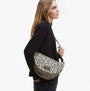 Barbour BOULEVARD Sling Bag Womens Jasmine Leopard side view on model, showcasing leopard print and zip closure.