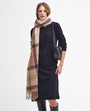 Barbour TARTAN BOUCLE Scarf Womens Muted Cabernet worn by a model, front view with a stylish dress and purse.