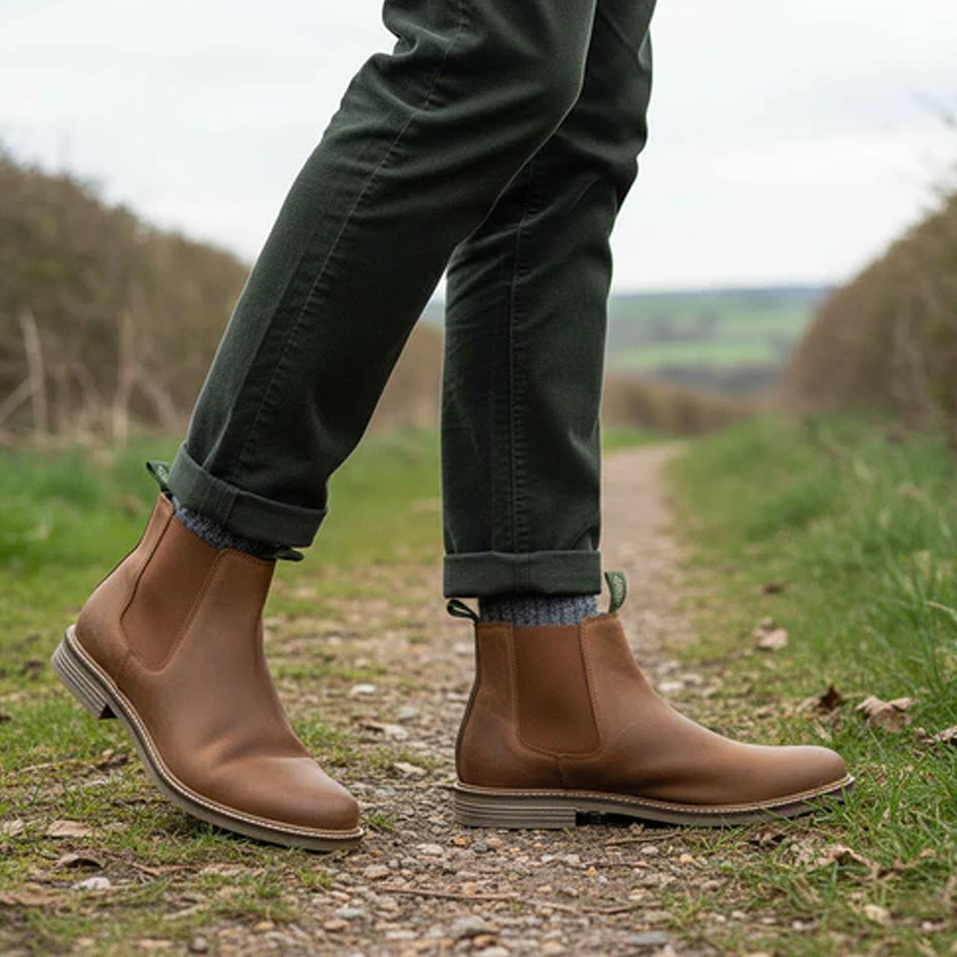 Barbour FARSLEY Mens Chelsea Boots Tan side view worn outdoors, showcasing leather design and elasticated side panels.