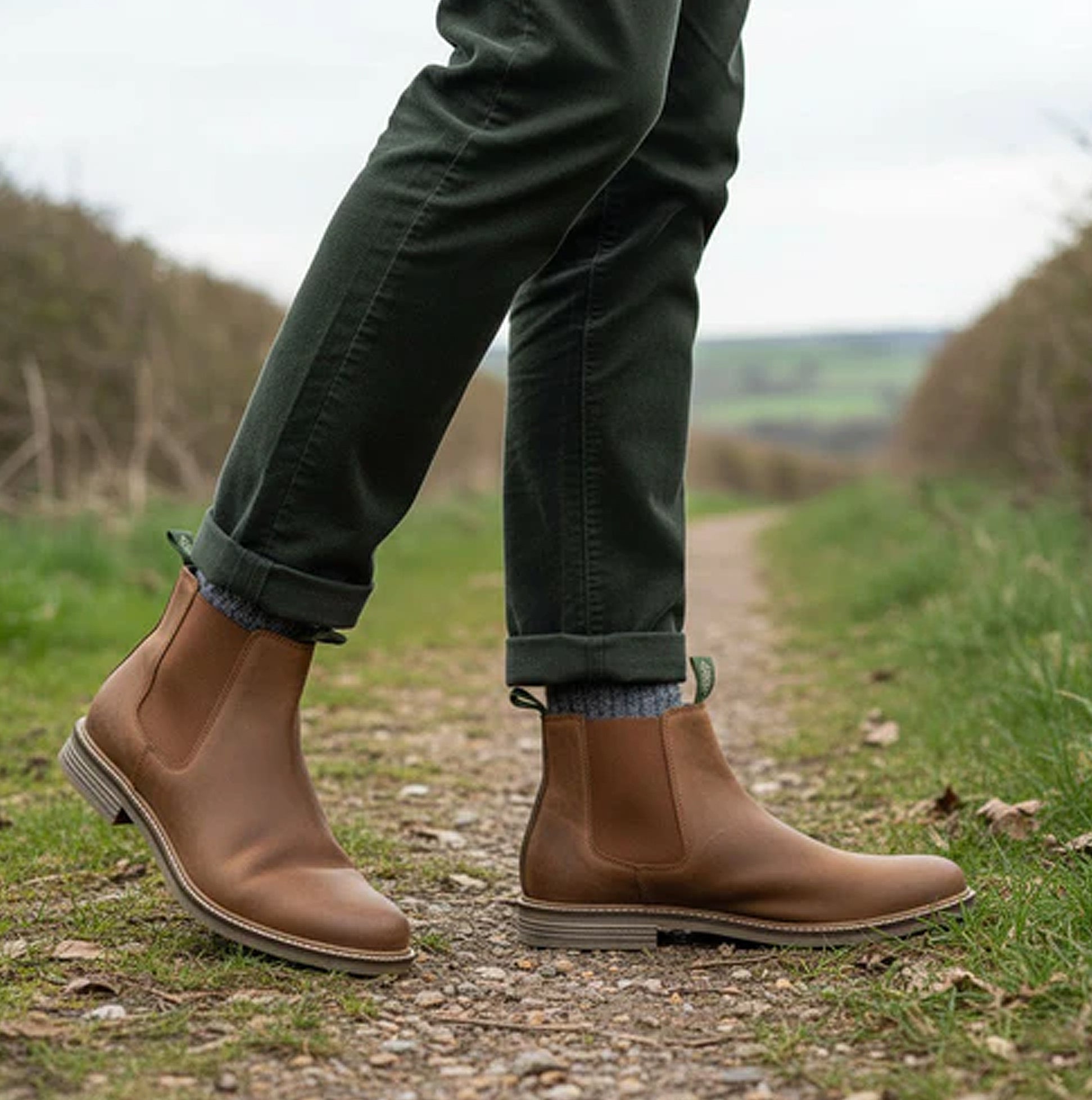 Barbour FARSLEY Mens Chelsea Boots Tan side view worn outdoors, showcasing leather design and elasticated side panels.