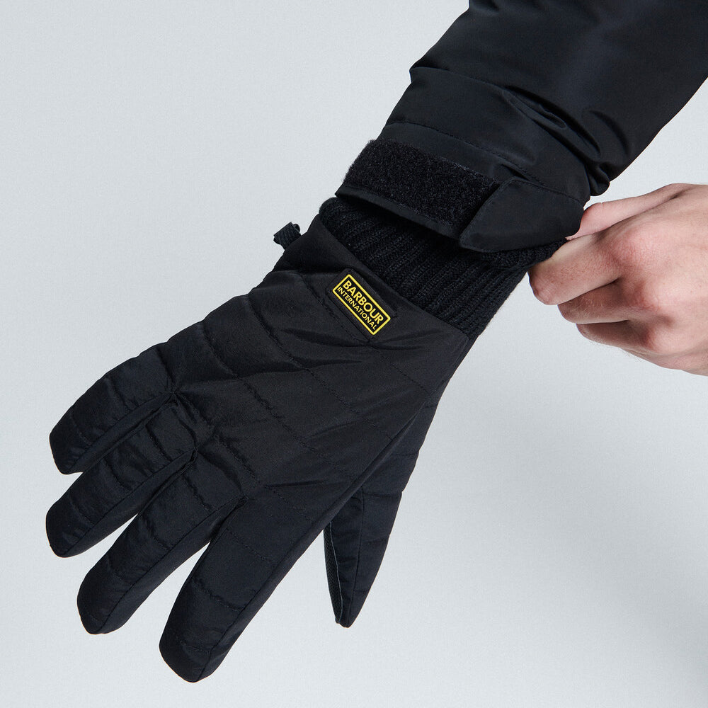Barbour PEAK LEGACY GLOVES Mens Black detail view showcasing baffle quilting and contrasting logo badge on cuff.