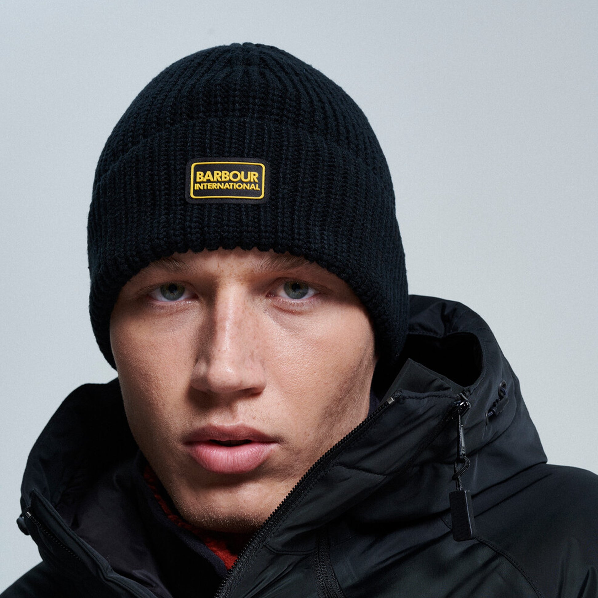 Barbour SWEEPER LEGACY Mens Beanie Black front view worn by model, featuring ribbed design and logo badge.