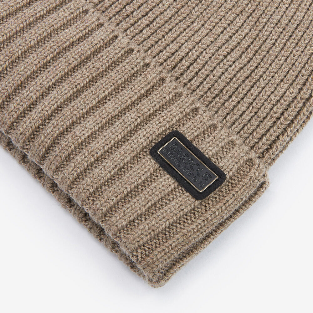Barbour CHESTER Mens Beanie Brindle close-up detail view showcasing rib-knit design and logo-embossed leather badge.