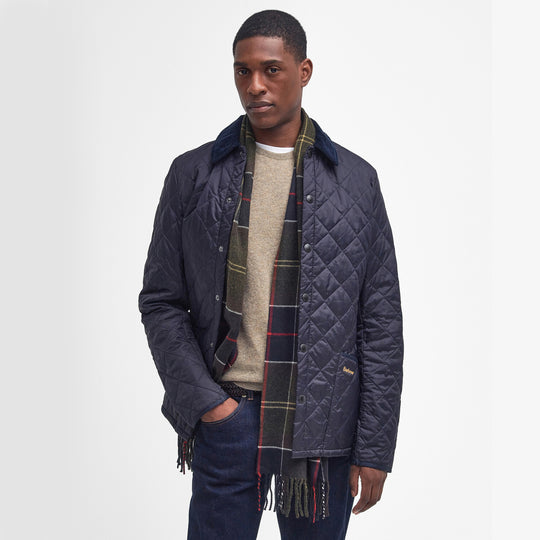 Barbour GALINGALE Unisex Adults Tartan Scarf Classic worn with a navy quilted jacket, showcasing plaid design and tasselled edges.