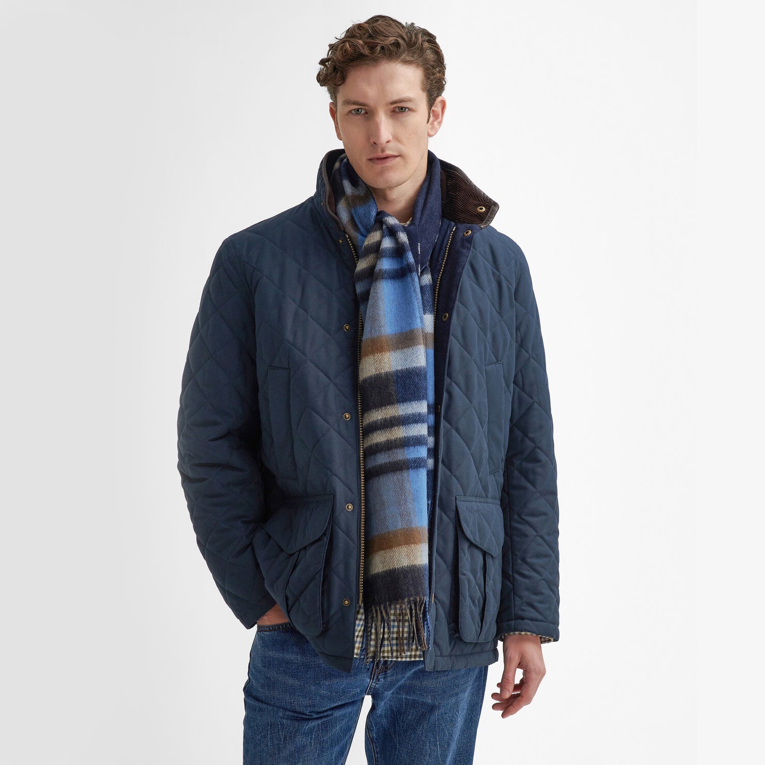 Barbour FIELD REVERSIBLE Scarf Unisex Adults Navy worn by a model in a quilted jacket, showcasing its check design.