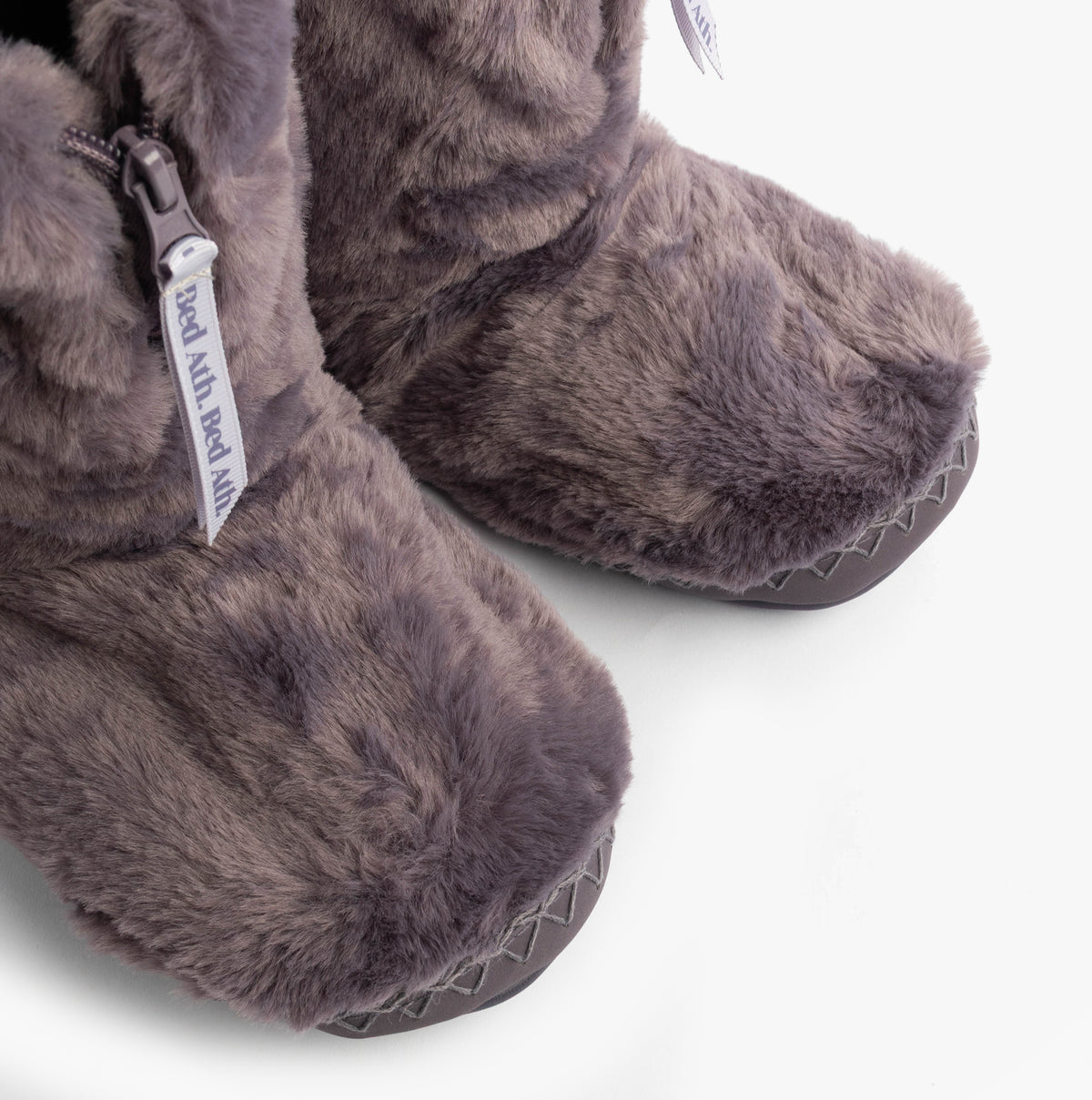 Bedroom Athletics MARILYN Womens Slipper Boots Frosted Grape detail view of faux fur upper and front outsole.