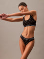 Calvin Klein MODERN COTTON Womens Thong Black Diamond Logo Print side view on model in a relaxed pose.