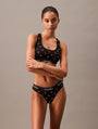Calvin Klein MODERN COTTON Womens Thong Black Diamond Logo Print front view model wearing black thong and sports bra