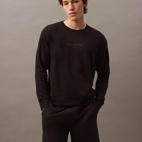 Calvin Klein MODERN TERRY Mens Sweatshirt Black front view worn by model with black shorts.
