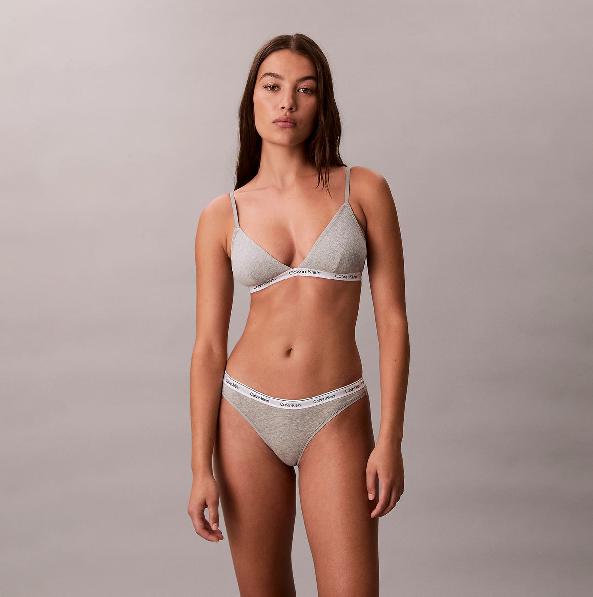 Calvin Klein Icon Logo Womens 3 Pack Thong Multi front view of model wearing gray thong and bralette set