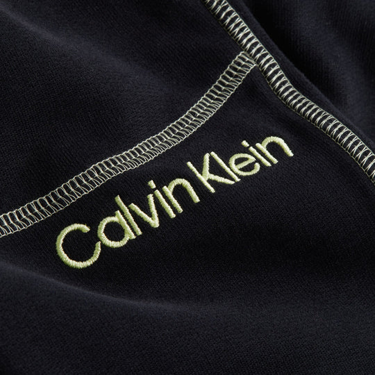 Calvin Klein FUTURE SHIFT Womens Joggers Black detail view of logo embroidery on fabric.