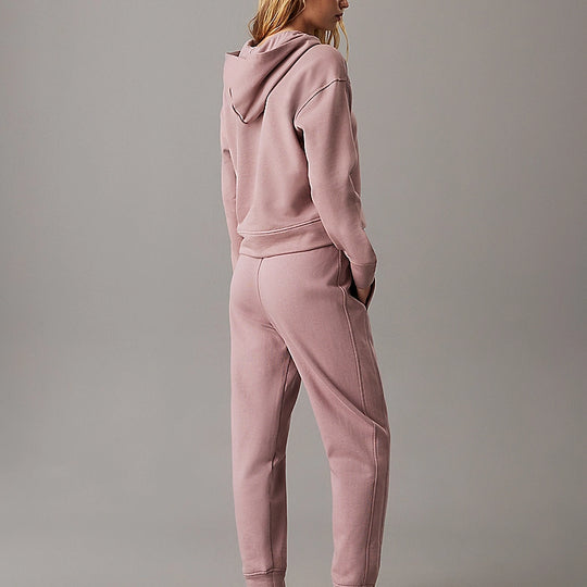 Calvin Klein TONAL LOGO LOUNGE Womens Hoodie Sand Trap, back view model wearing comfortable hoodie in sand trap color.
