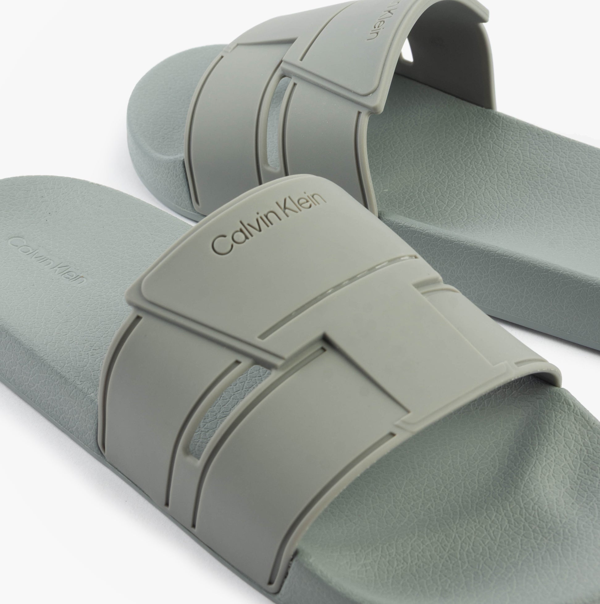 Calvin Klein POOL SLIDE DOUBLE T Mens Sliders Granite Road side view showing the synthetic upper and slip-on design.