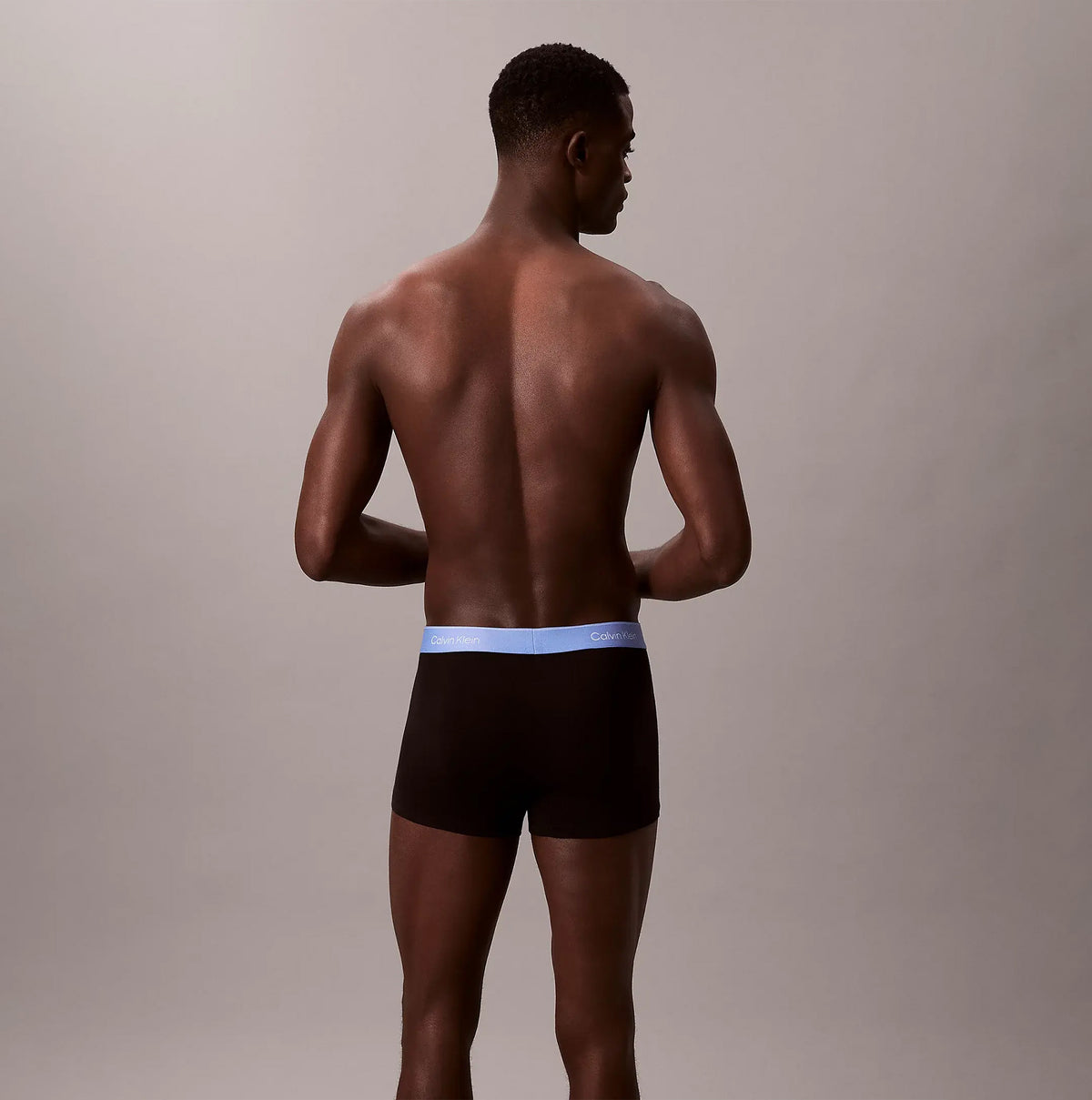 Calvin Klein TRUNK 5 Pack Mens Multicoloured - Back view of model wearing black trunk underwear with blue waistband.