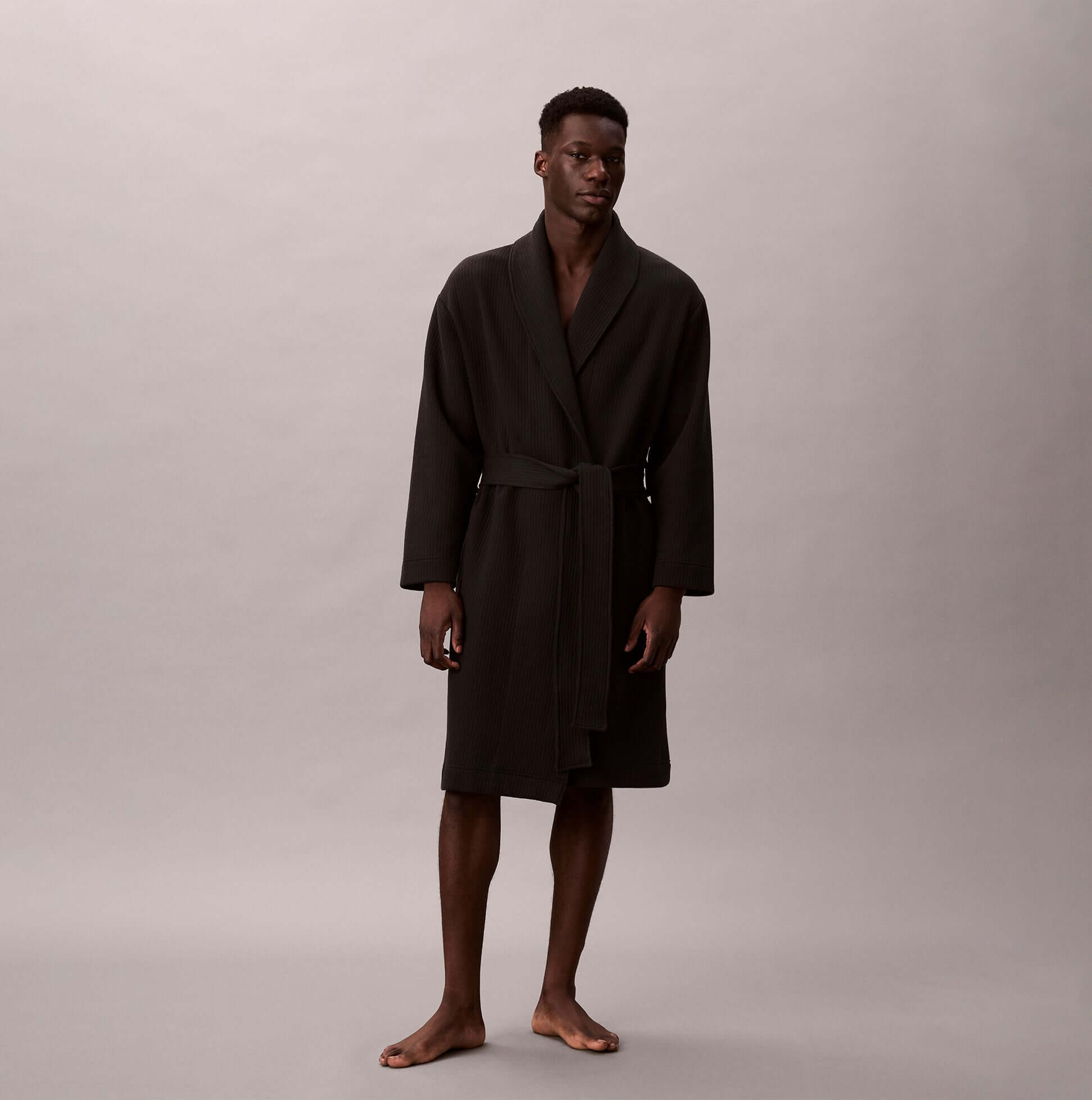 Calvin Klein QUILTED ROBE Mens Bathrobes Black front view of a model wearing a black long robe.