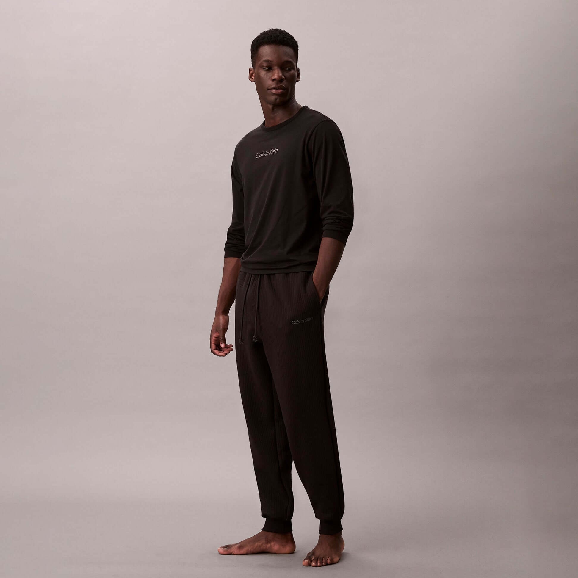 Calvin Klein QUILTED JOGGER Mens Joggers Black side view model wearing black joggers and top