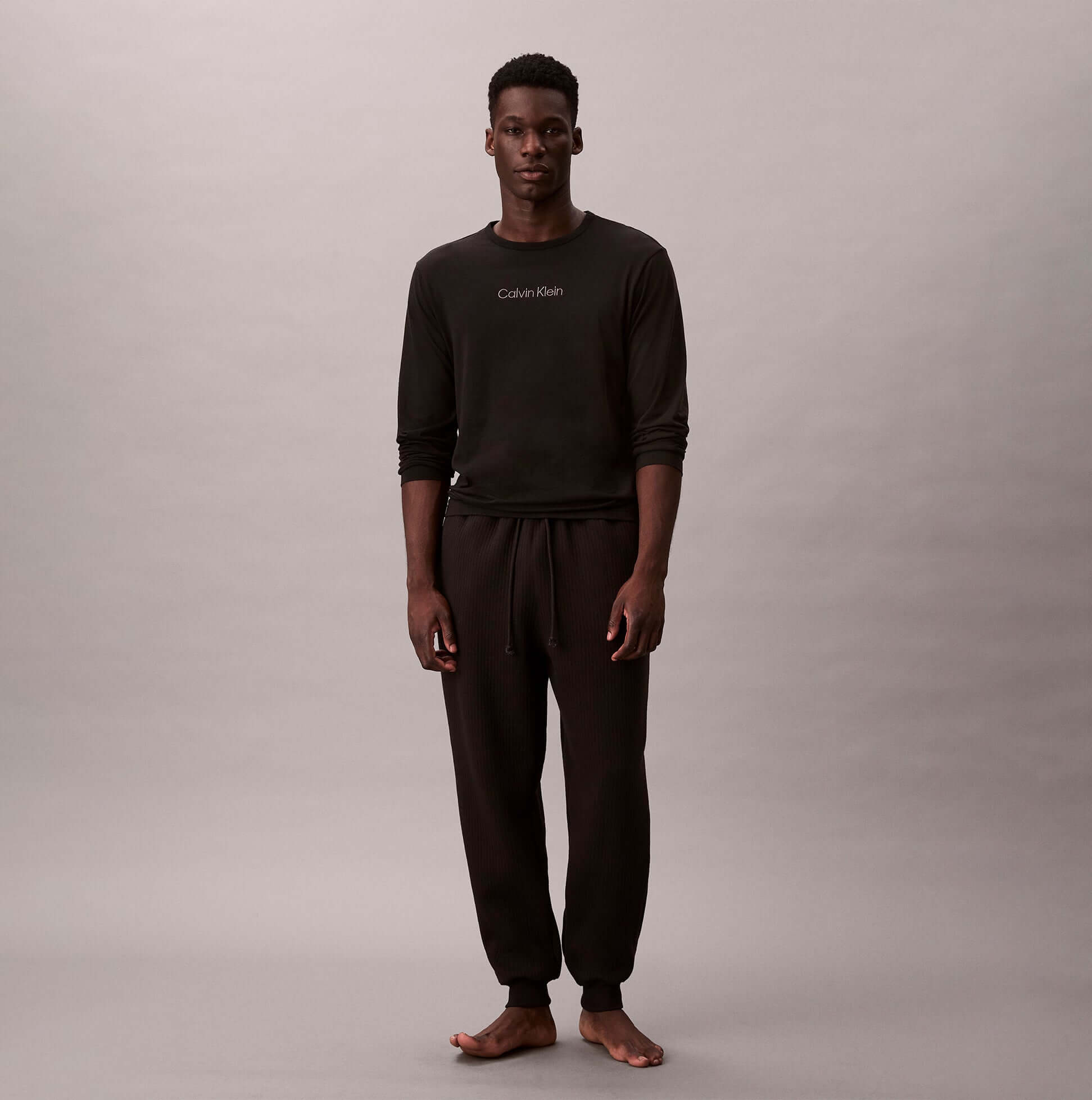Calvin Klein QUILTED JOGGER Mens Joggers Black front view on model wearing matching top.
