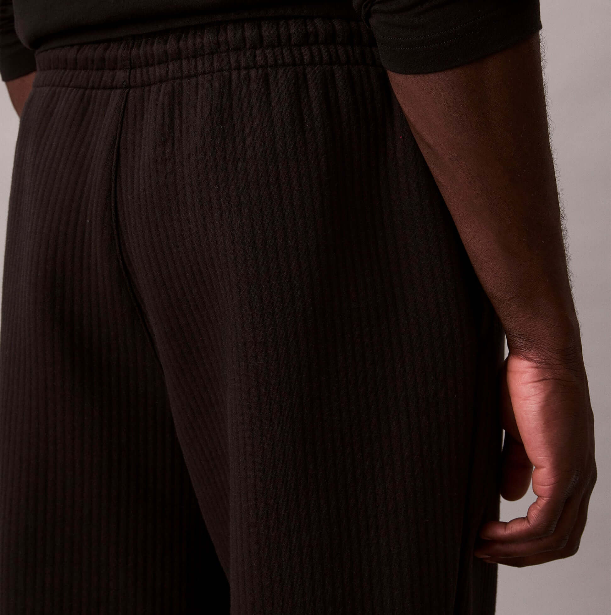 Calvin Klein QUILTED JOGGER Mens Joggers Black side view, showcasing the textured fabric and elastic waistband.