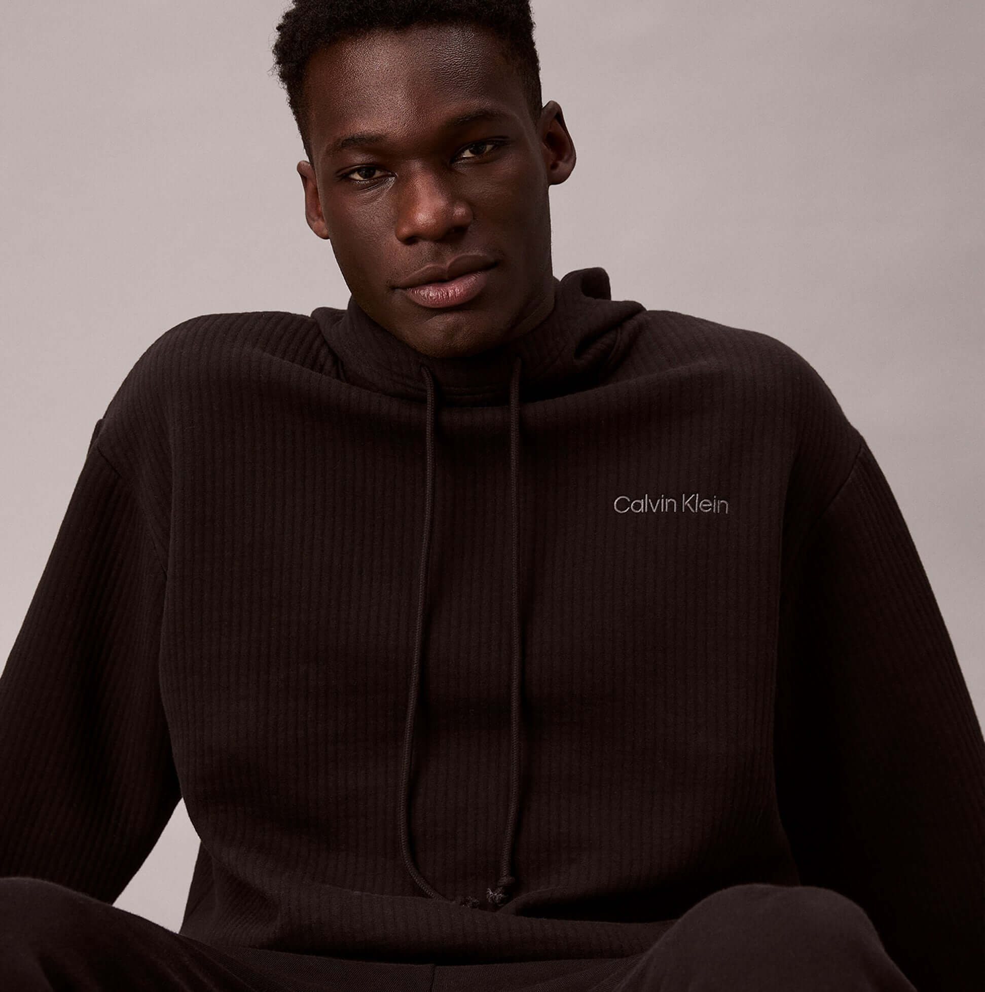 Calvin Klein QUILTED HOODIE Mens Hoodies Black front view of model wearing hoodie with logo detail
