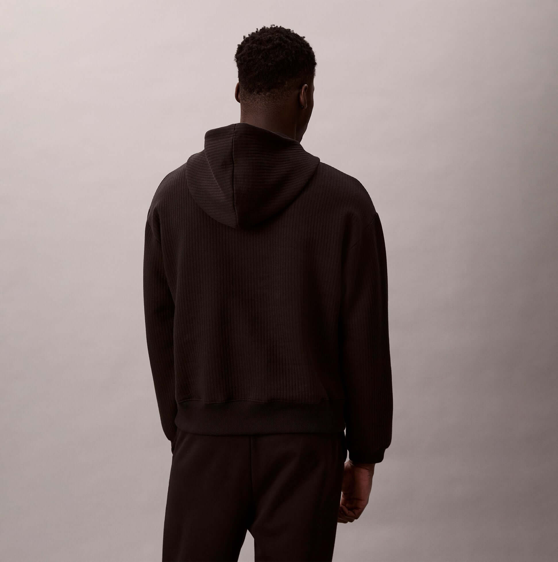 Calvin Klein QUILTED HOODIE Mens Hoodies Black back view showing hoodie design in black color.