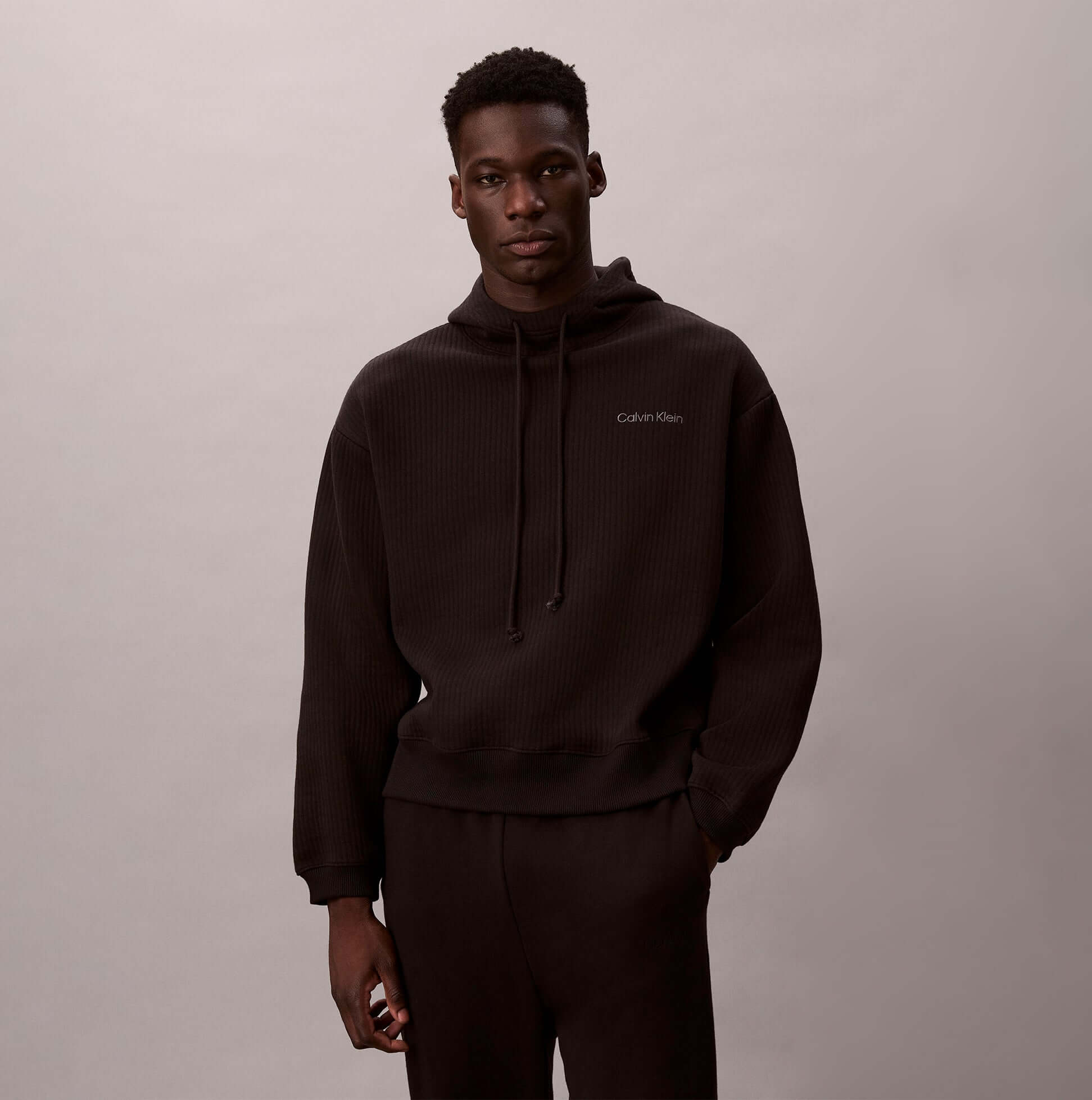 Calvin Klein QUILTED HOODIE Mens Hoodies Black front view model wearing hooded sweatshirt.