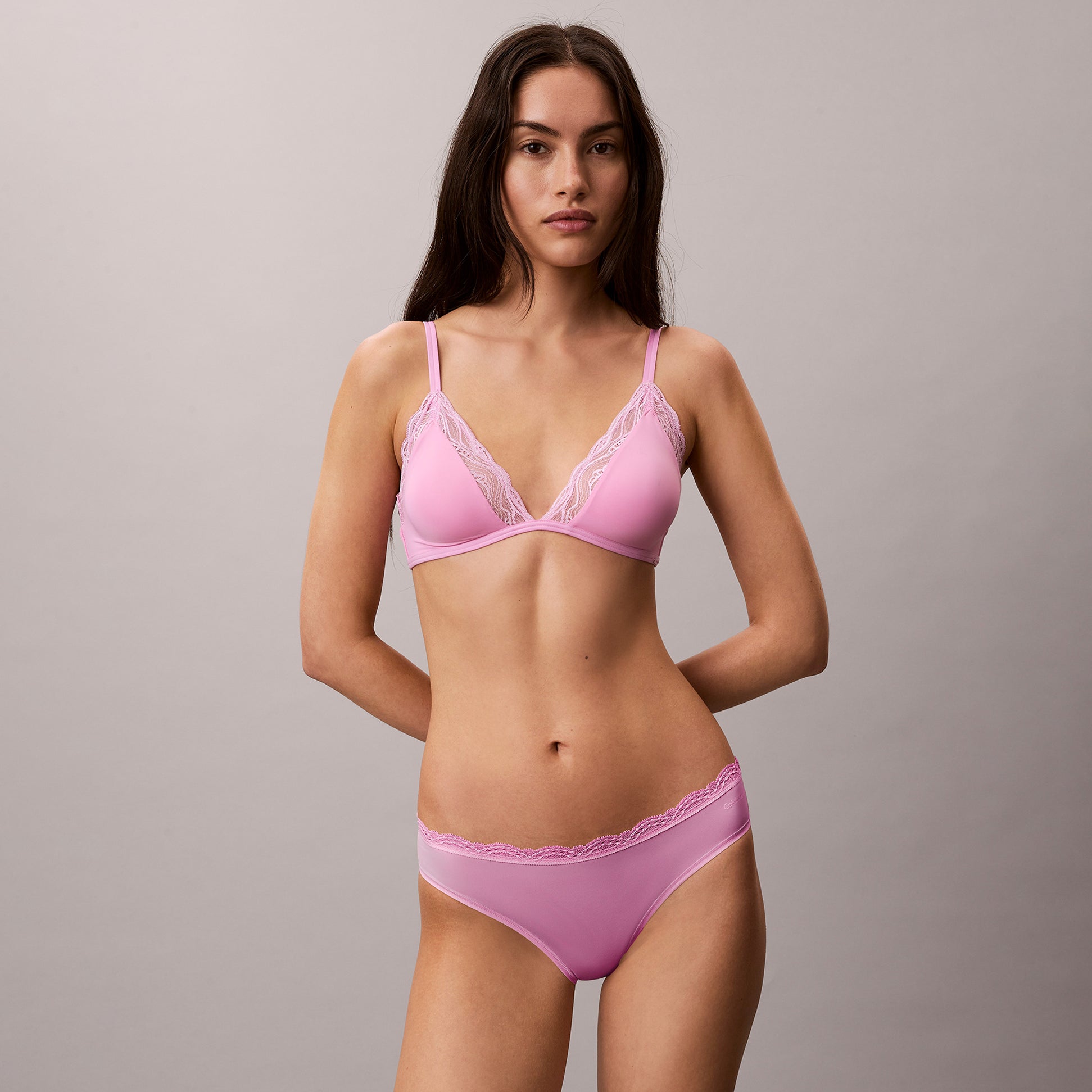 Calvin Klein UNLINED TRIANGLE Sensual Stretch Lace Pink front view on model, showcasing lace details and triangle design.
