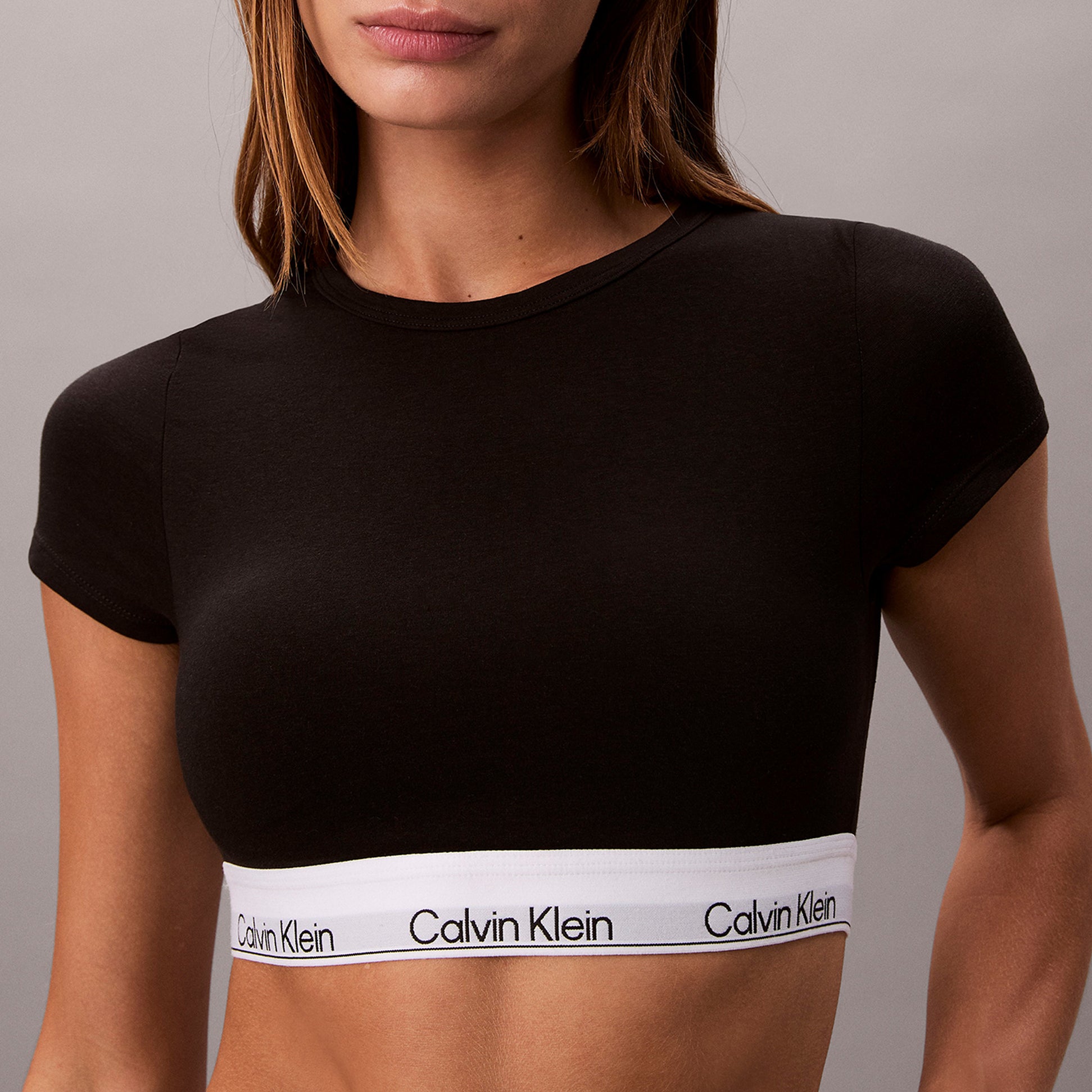 Calvin Klein T-SHIRT BRALETTE Womens Black front view showcasing the soft fabric and signature logo band.