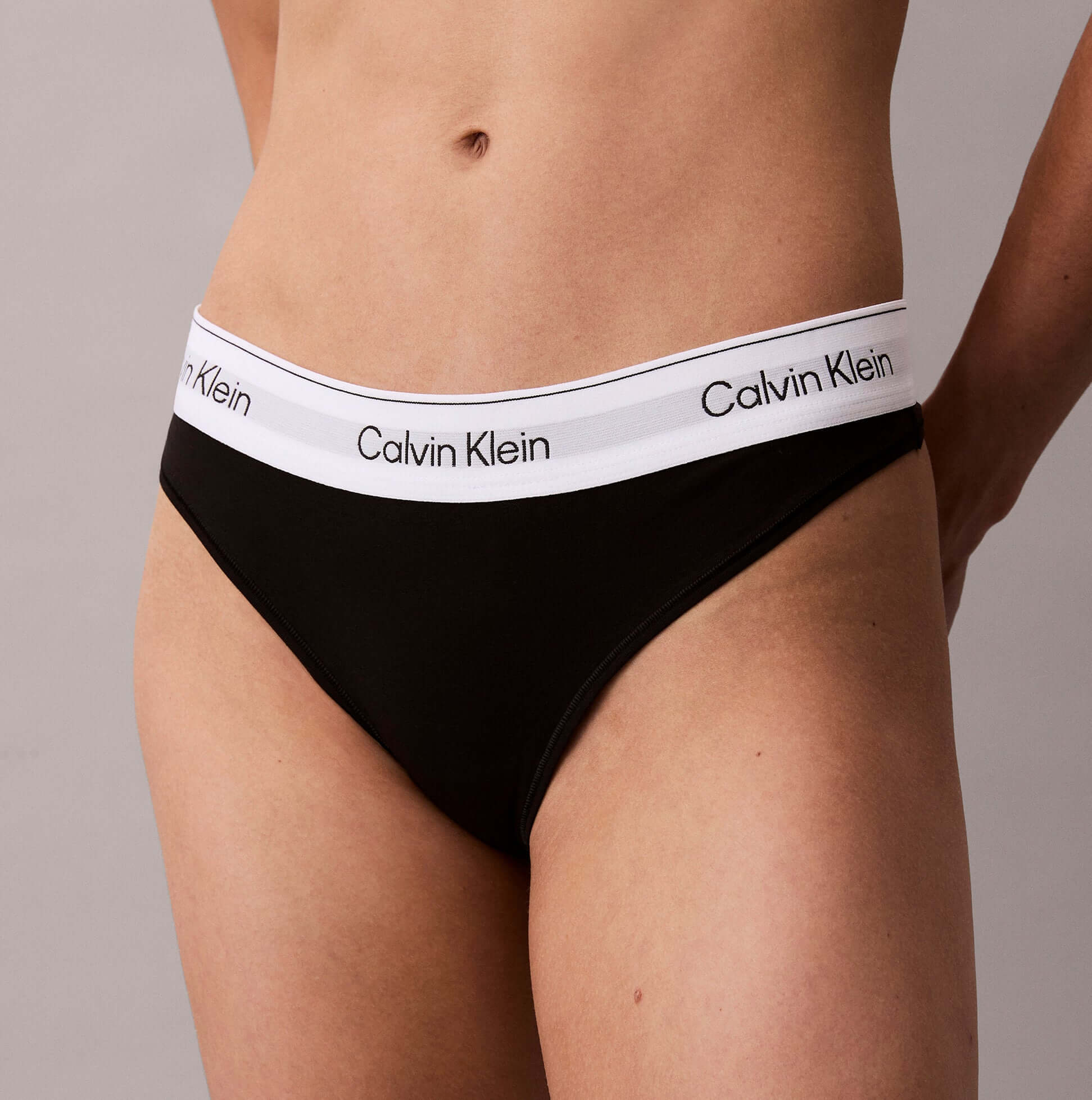 Calvin Klein Icon Cotton Modal Womens Thong Black side view showcasing the black fabric and logo waistband