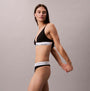 Calvin Klein Icon Cotton Modal Womens Thong Black side view on model showcasing comfortable fit and stylish design.
