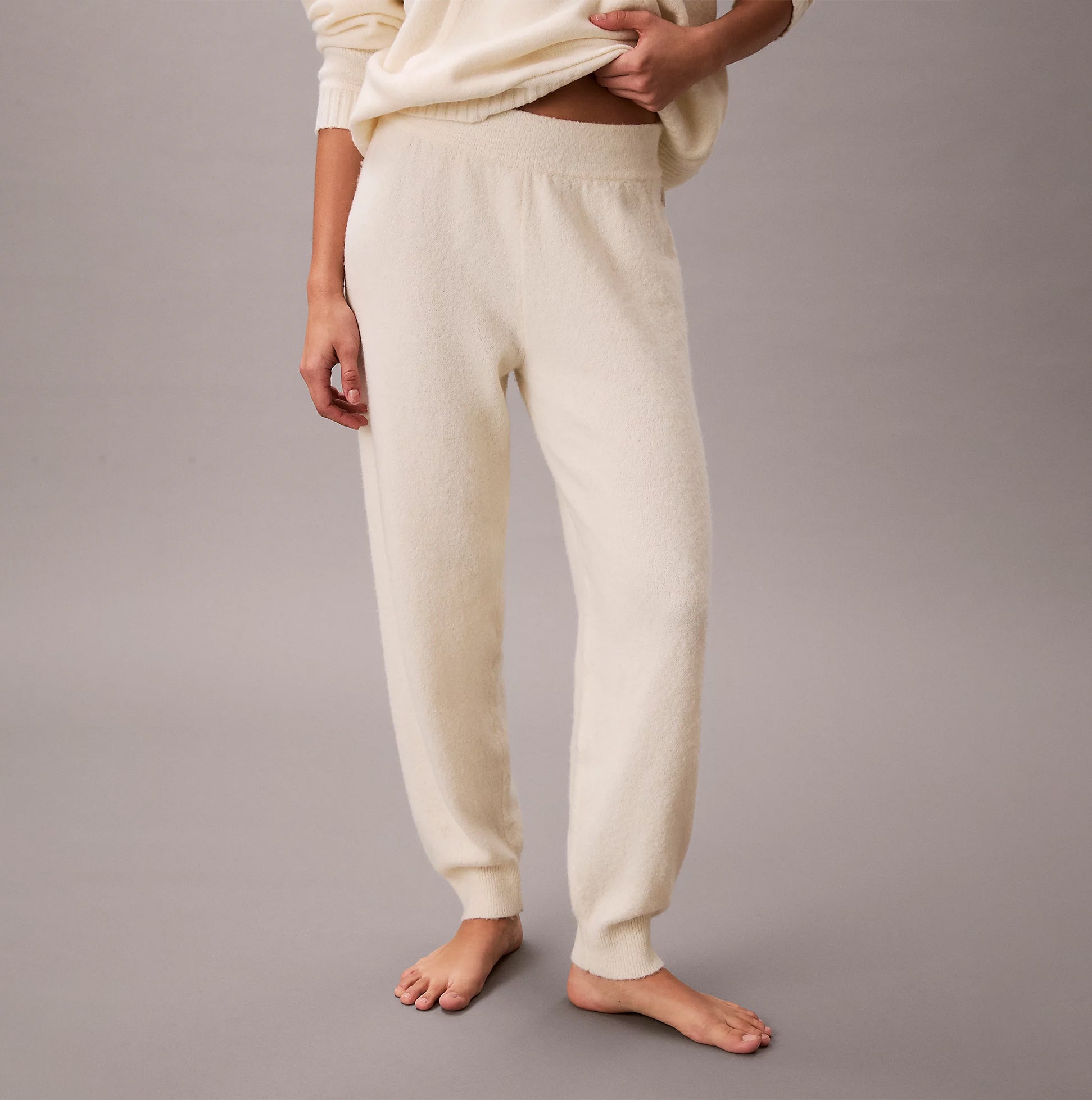 Calvin Klein PLUSH JOGGER. Womens Ivory. Side view showcasing soft fabric and relaxed fit.