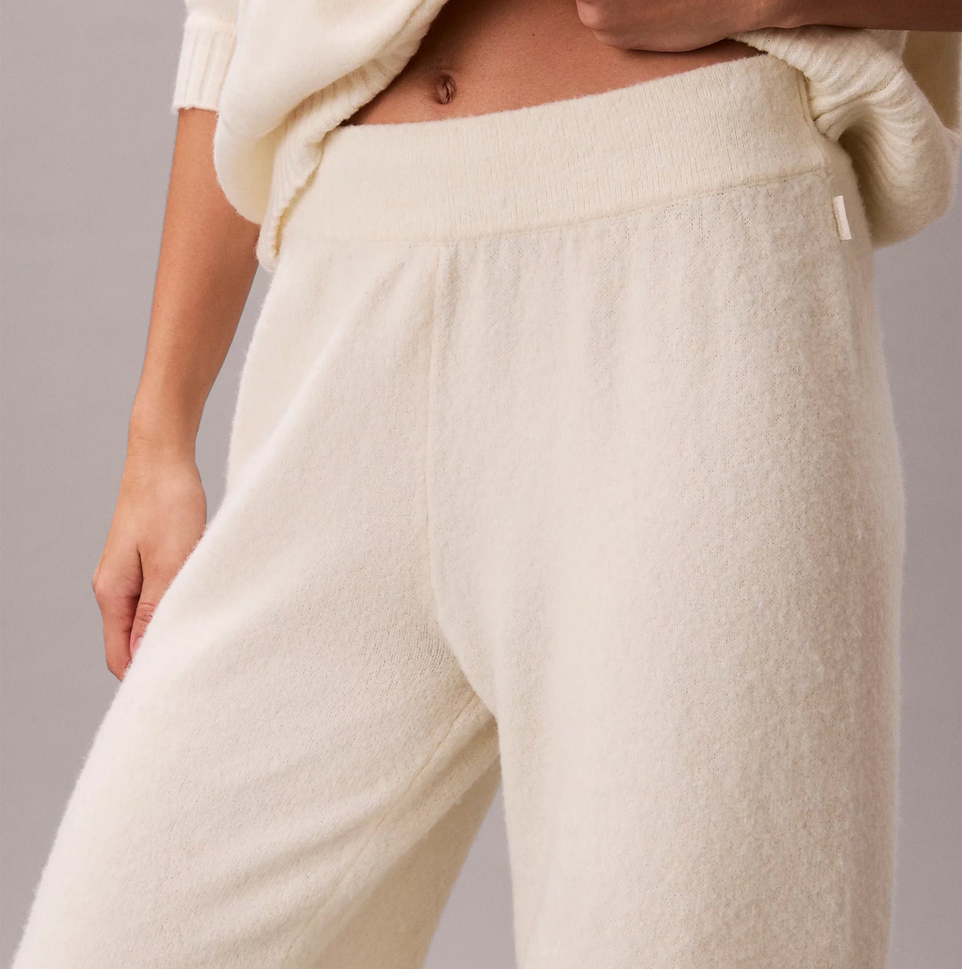 Calvin Klein PLUSH JOGGER. Womens Ivory, front view showing soft fabric and elastic waistband.