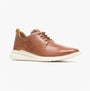 Brown leather shoe with white sole on a light gray background