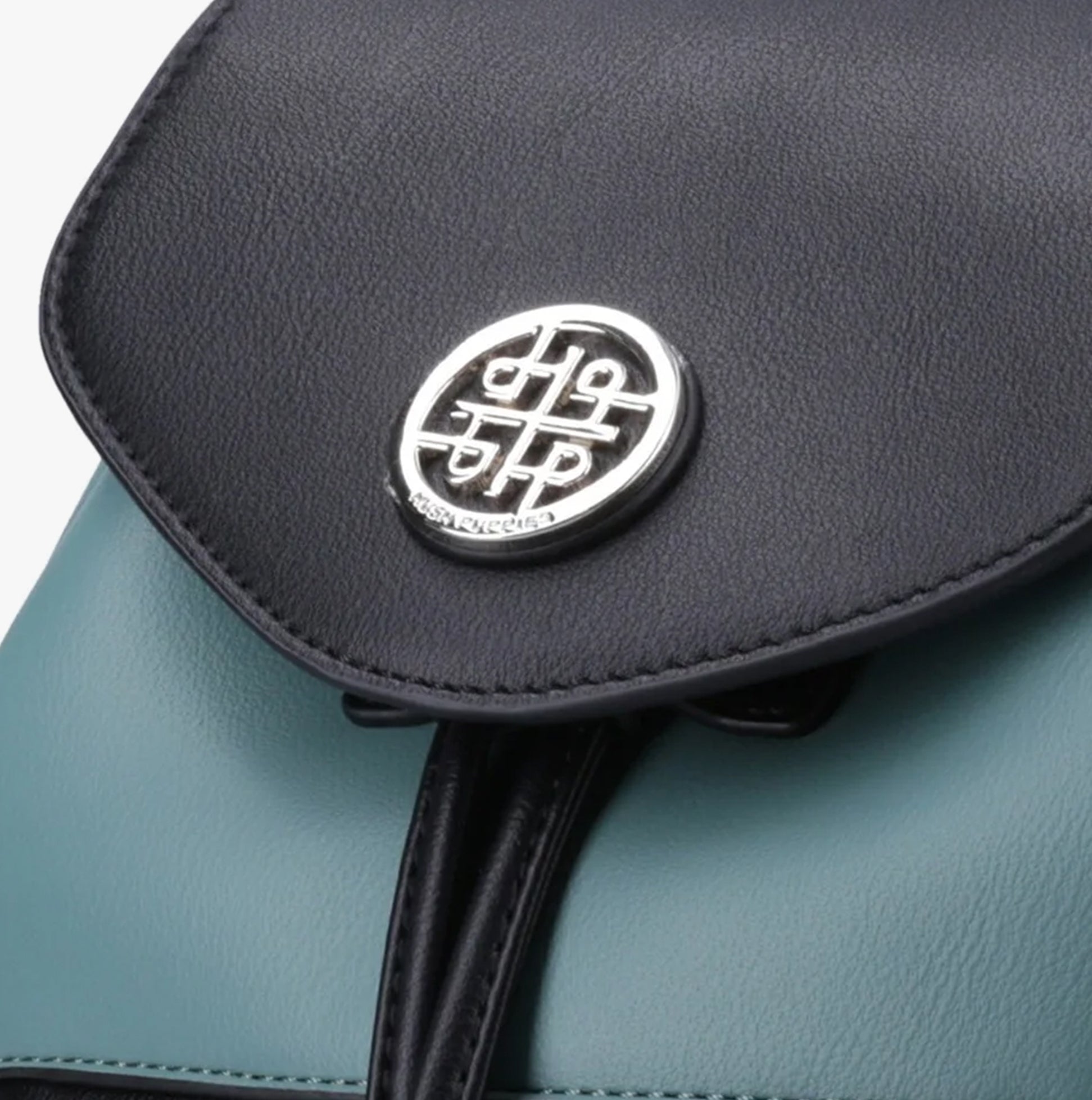 Hush Puppies MONA Womens Back Packs Light Turquoise detail view of the closure and logo.