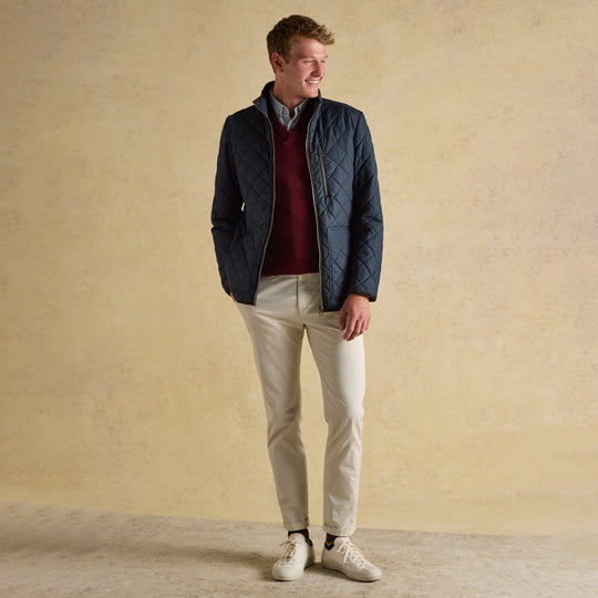 Joules MAYNARD Mens Jacket Navy front view worn by model with zip closure, paired with light trousers and white sneakers.