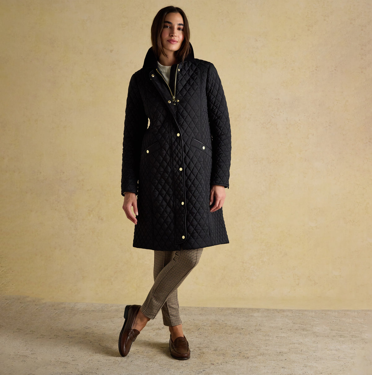 Joules ROSEWELL Longline Quilted Showerproof Coat with Collar Black front view, model wearing coat with button and zip closure.