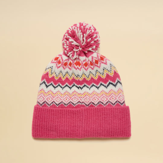 Joules KARA BOBBLE Womens Beanie Hat Pink top view with pom pom and colorful ethnic patterns on a beige background.