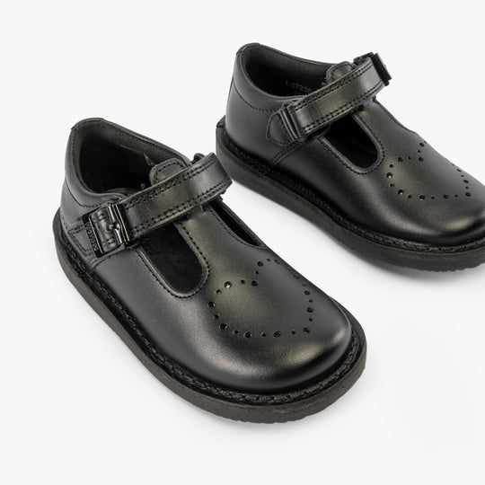 Kickers 117236 KOPI HEART T BAR Infant Girls School Shoes Black side view showing the sleek black leather upper and buckle closure.
