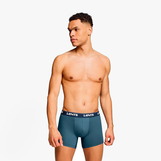 Levi's REPEAT LOGO Mens 3 Pack Trunks Navy Combo side view on male model wearing trunks with elastic waistband.