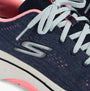 Skechers 125311/NVHP GO WALK ARCH FIT 2.0 - VIVID SUNSET Womens Trainers Navy/Hotpink close-up view of laces and logo.
