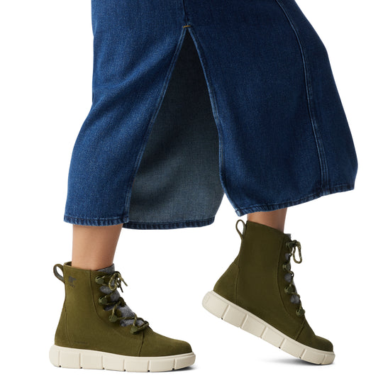 Sorel EXPLORER III JOAN Womens Winter Boots Green side view on model's feet with denim skirt