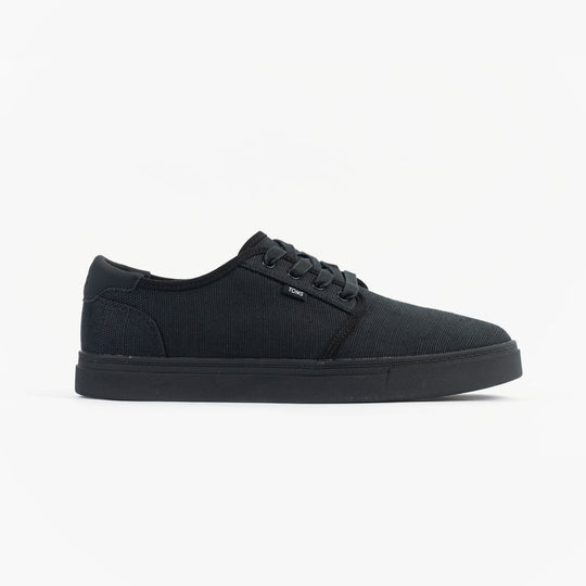TOMS CARLO 2.0 Mens Trainers Black side view showcasing canvas upper and rubber sole.