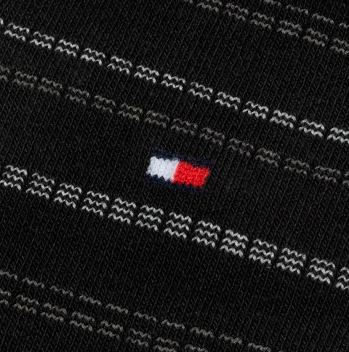 Detail view of Tommy Hilfiger 4 Pack Giftboxed Classic Mens Crew Socks Black showcasing logo design.
