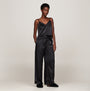 Tommy Hilfiger COMFORT HOME SLIP Womens Slippers Black worn with satin pajama set, side view of model.