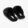 Tommy Hilfiger COMFORT HOME SLIP Womens Slippers Black side view showing soft textile upper and slip-on design.